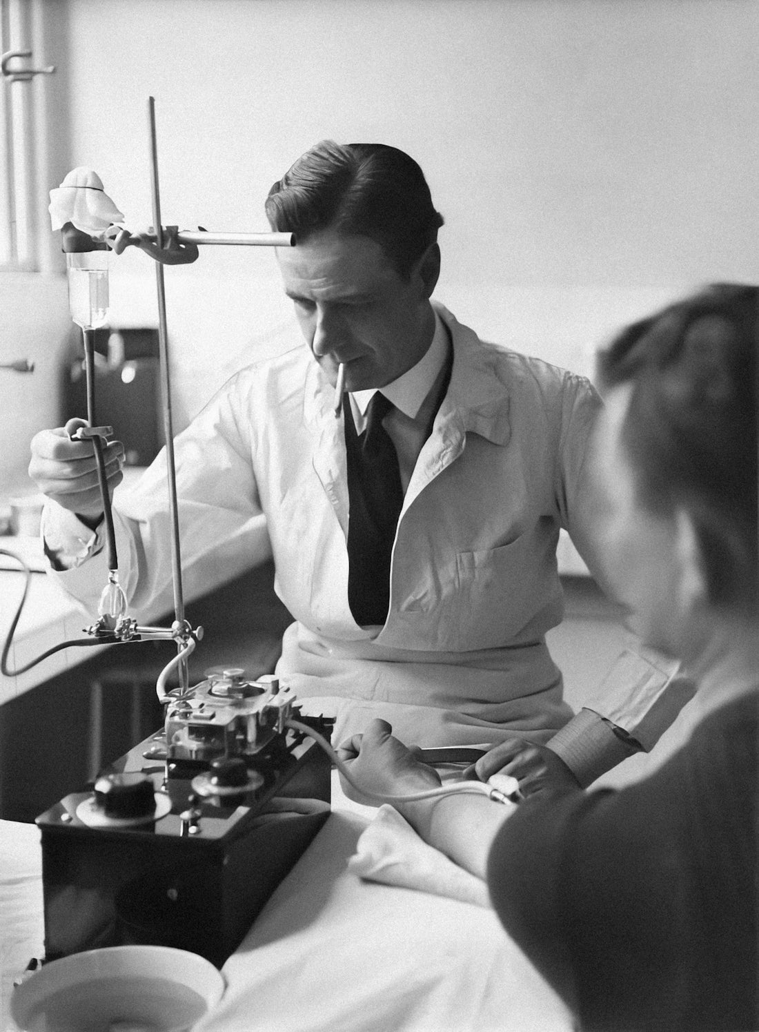 a black and white photo of a man in a doctor's office