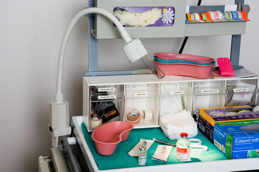 a cluttered desk with a hair dryer, hairdryer, and other